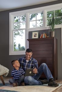 father and son looking at ipad